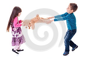 Boy and girl pulling toy bear photo