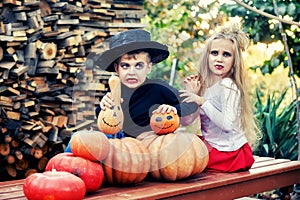 Boy and girl with pumpkins for Halloween