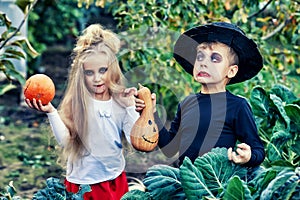 Boy and girl with pumpkins for Halloween