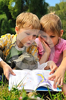 Boy and girl are reading a book