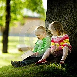 Boy and girl reading a book