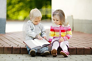 Boy and girl reading book