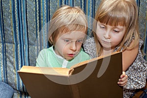 Boy and girl are reading book