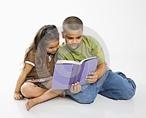 Boy and girl reading book.