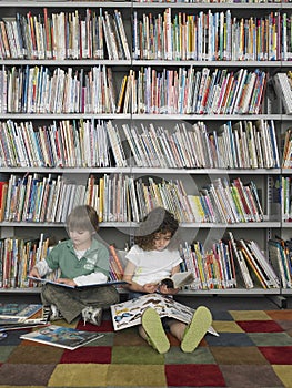 Boy And Girl Reading Books In Library