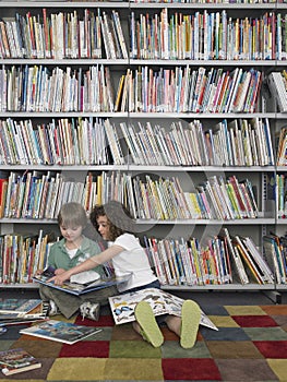 Boy And Girl Reading Books In Library