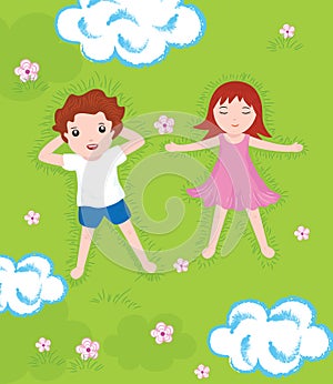 Boy and girl relax on a green meadow