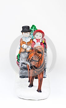 boy and girl riding the Horsecar ,Christmas decoration ceramics, earthenware isolated on white background...