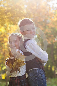 Boy and girl in school uniform with maple leaves