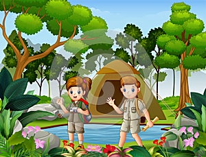 Boy and girl scout camping in nature