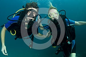 Boy and girl scuba dive together