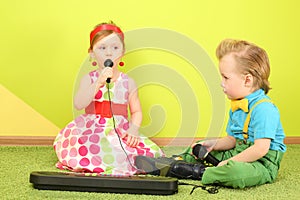 Boy and girl sitting on the floor in front of a