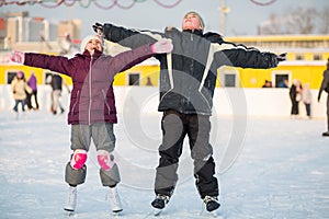 Boy and girl skating on rink