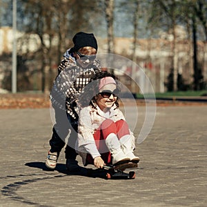 Boy and girl skating on the street