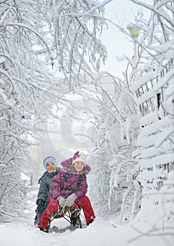 Boy And Girl at sledging Through Snowy