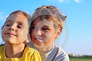 Boy and girl smile and look toward