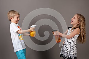 Boy and girl squirting water