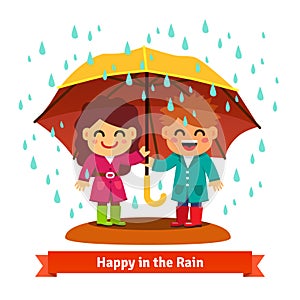 Boy and girl standing in the rain under umbrella