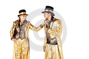 Boy and girl on stilts dressed in gold