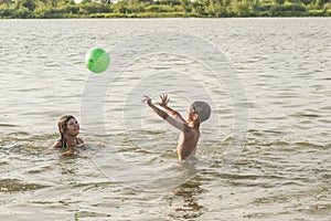 Boy and girl swimming in a pond