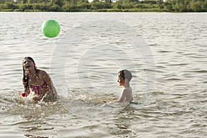 Boy and girl swimming in a pond