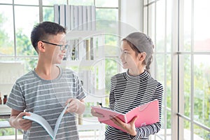 Boy and girl talking and smiling in classroom