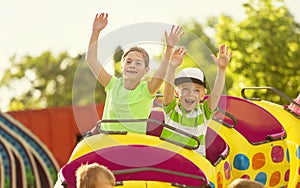 Boy and Girl on a thrilling roller coaster ride at an amusement park