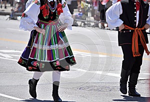 Boy and girl in traditional folk costumes from Lowicz perform on the street of Chicago.