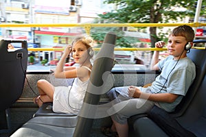 A boy and a girl traveling in a tour bus