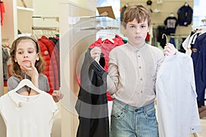 The boy with the girl trying on clothes