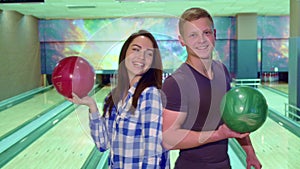 Boy and girl turn face to face at the bowling