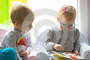 Boy and girl twins reading book