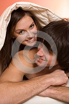 Boy with girl under blanket