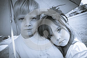 Boy and girl under umbrella