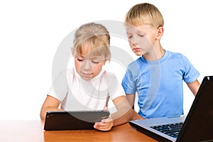 Boy and girl using digital pad and laptop