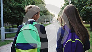 Boy and girl walking with a school bags