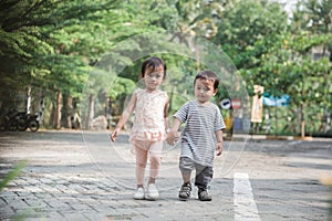 Boy and girl walking together and holding hand