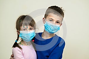Boy and girl wearing blue protective medical mask ill with chickenpox, measles or rubella virus with rashes on body. Children