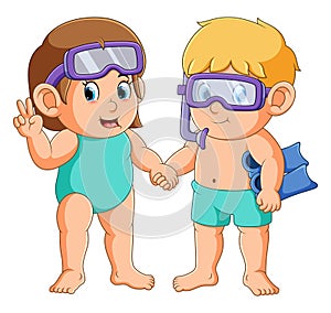 The boy and girl is wearing the flippers and goggles for diving