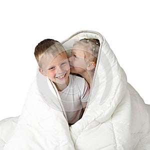 Boy and girl whispering under blanket