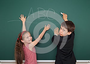 Boy and girl write on school board