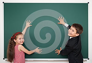 Boy and girl write on school board