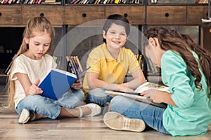 Boy and girls reading books