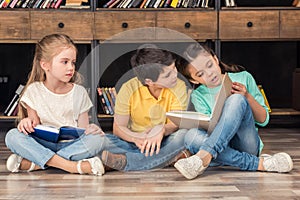 Boy and girls reading books