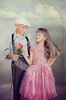 The boy gives a flower to the girl