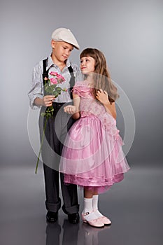 The boy gives a flower to the girl