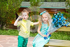 The boy gives a flower to a girl child on happy birthday. Celebration concept and childhood, love