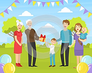 Boy Giving Holiday Present to Happy Grandfather, Relatives Congratulating Grandparent with Birthday Party Event Outdoors