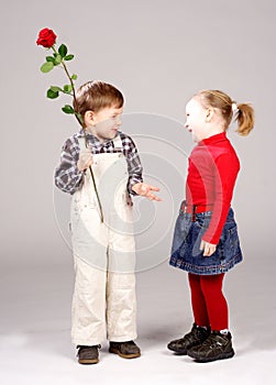 Boy giving preschool girl rose