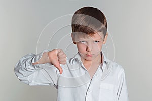 Boy giving thumbs down sign